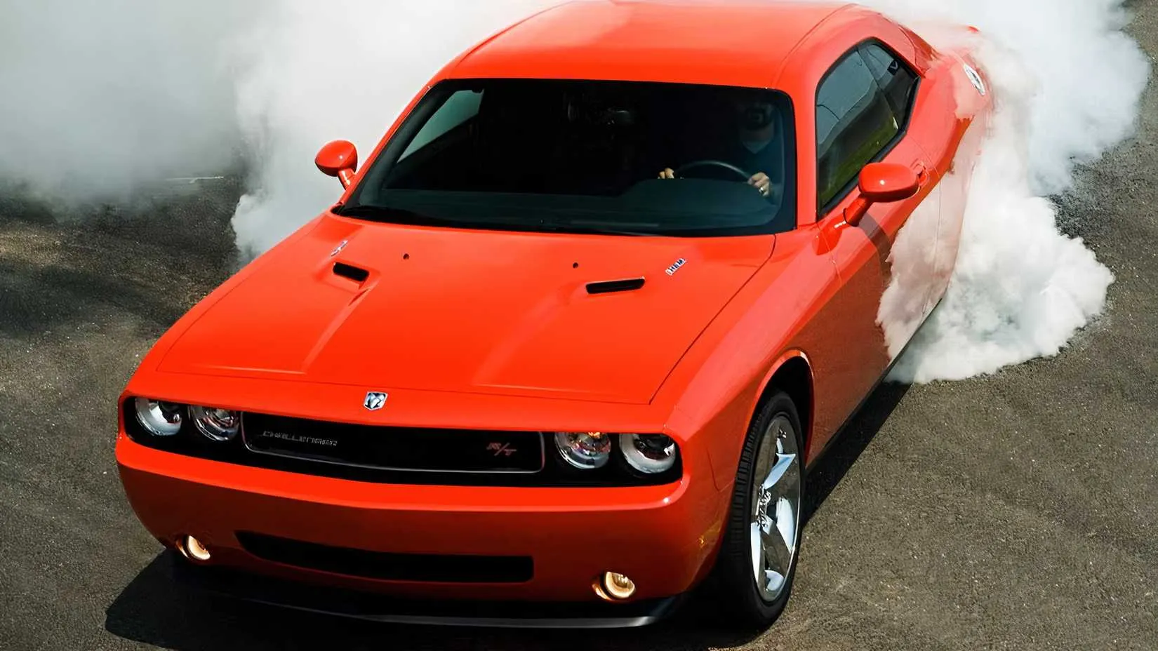 A 2009 Dodge Challenger R/T in orange, a modern coupe with retro styling