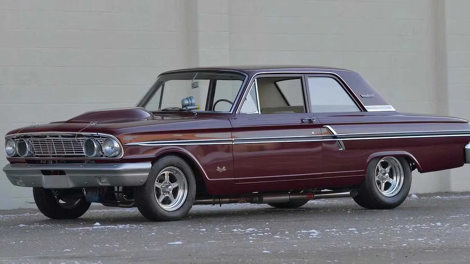 1964 Ford Fairlane Thunderbolt in a classic drag-race stance ready to launch