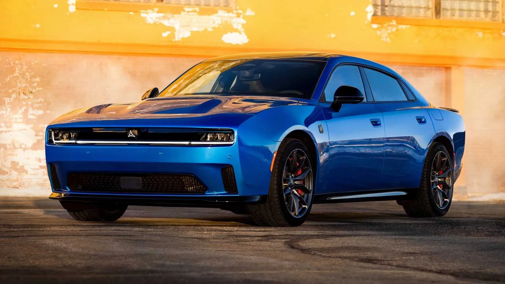 Rear three‑quarter view of the 2026 Dodge Charger Daytona Scat Pack four‑door showing the electric sedan&rsquo;s profile