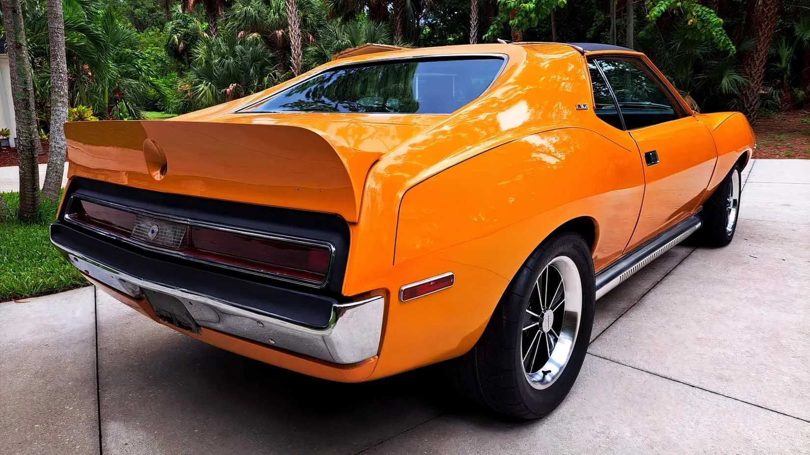 The engine bay of a 1971 AMC Javelin AMX 401, revealing the massive 401 V8 with its air cleaner and factory decals, a clean and original-looking setup.