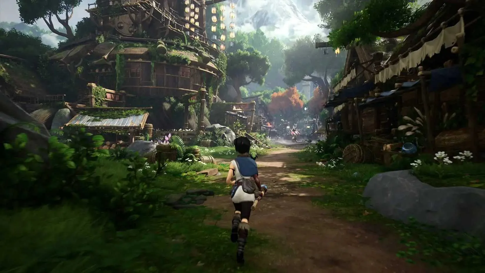 Kena and her Rot companions exploring a lush forest