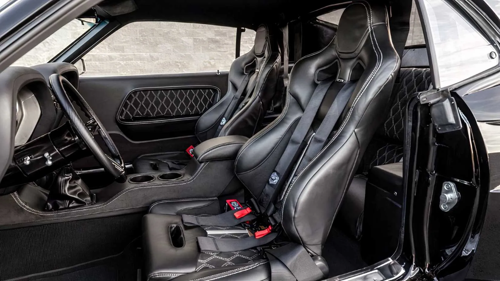 The handcrafted interior with TMI high-back seats, custom AutoMeter gauges, and German square-weave carpeting