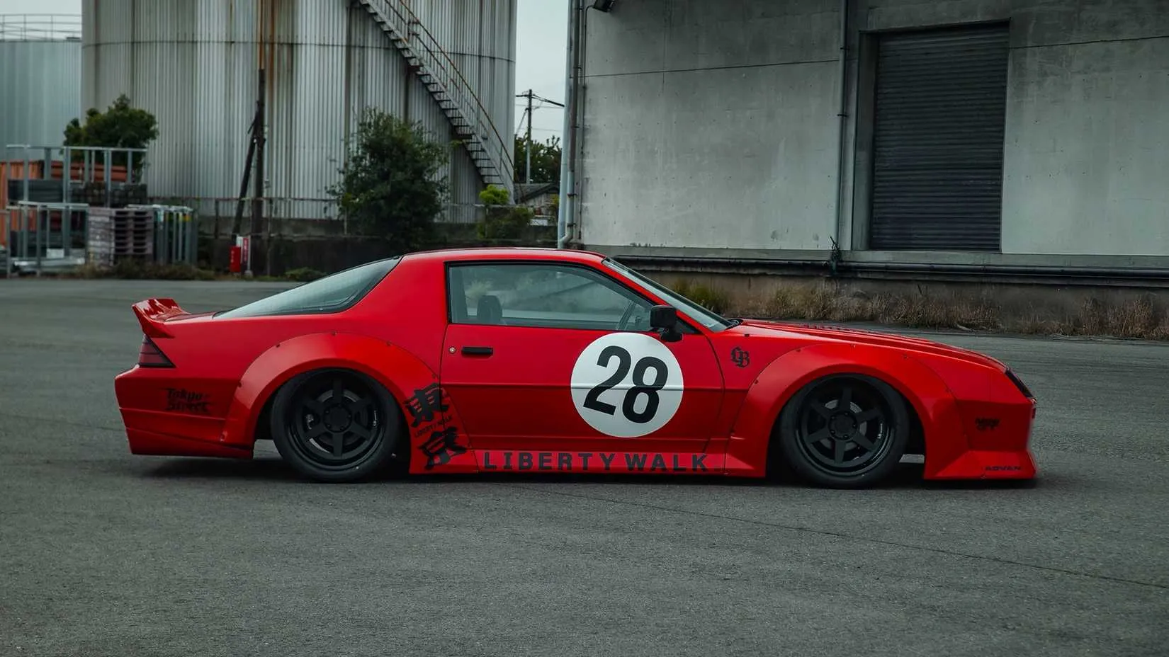 Side profile of the Liberty Walk Camaro showing extended fenders, side skirts, and lowered stance