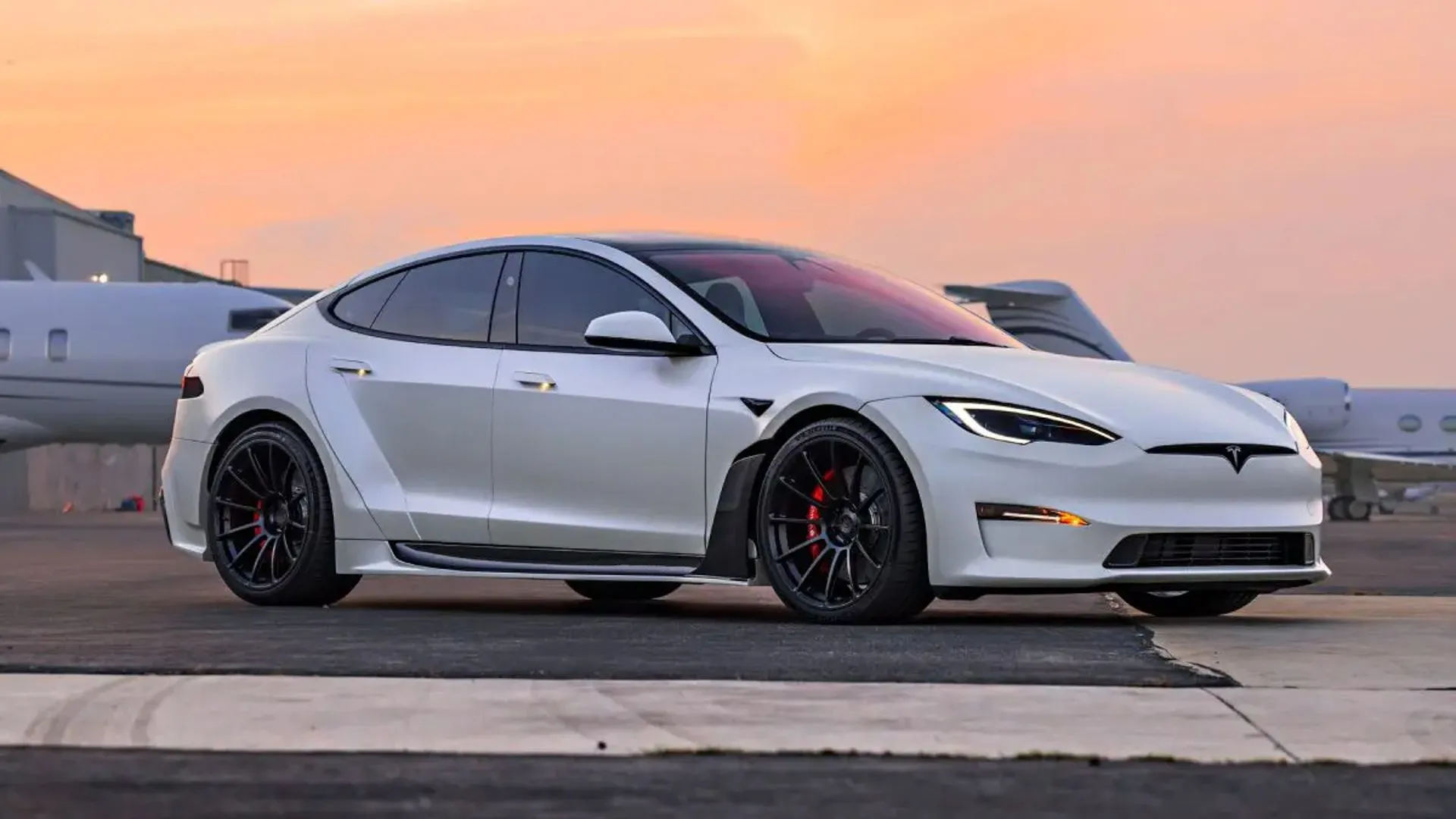A Tesla Model S Plaid, representing the kind of production EV performance benchmark the C7 conversion challenges