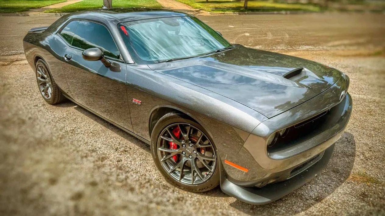 The cockpit of the high-mileage Challenger, showing a gauge cluster that has witnessed countless sunrises