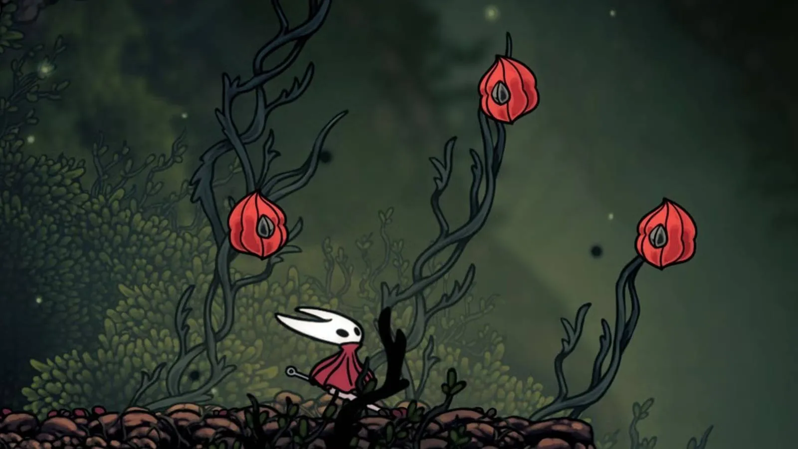A streamer stands in front of her setup, dancing on a pad while looking at a screen showing Silksong gameplay.