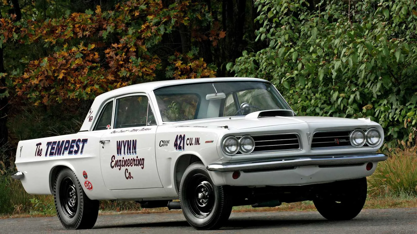 1963 Pontiac Tempest Super Duty in a vintage racing scene, demonstrating speed