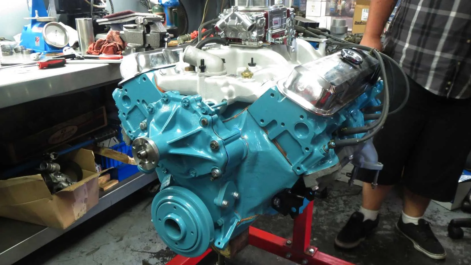 Pontiac 455 cubic-inch V8 engine on a stand, showing the valve covers and carburetor, a testament to 1970s muscle engineering