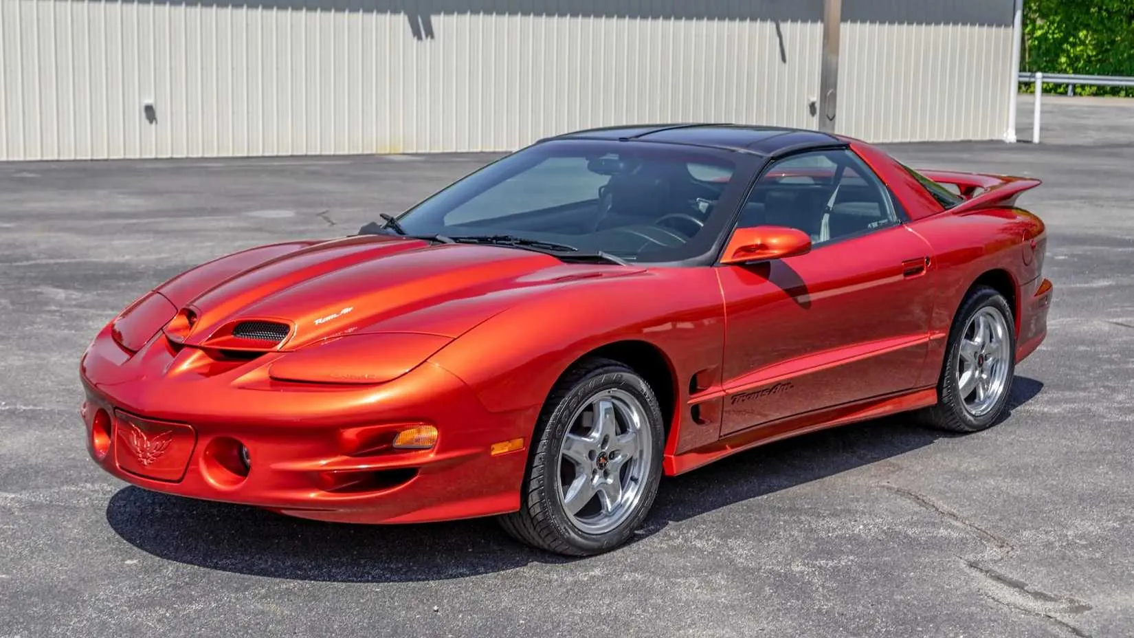 A silver 2002 Pontiac Firebird Trans Am WS6 parked on grass