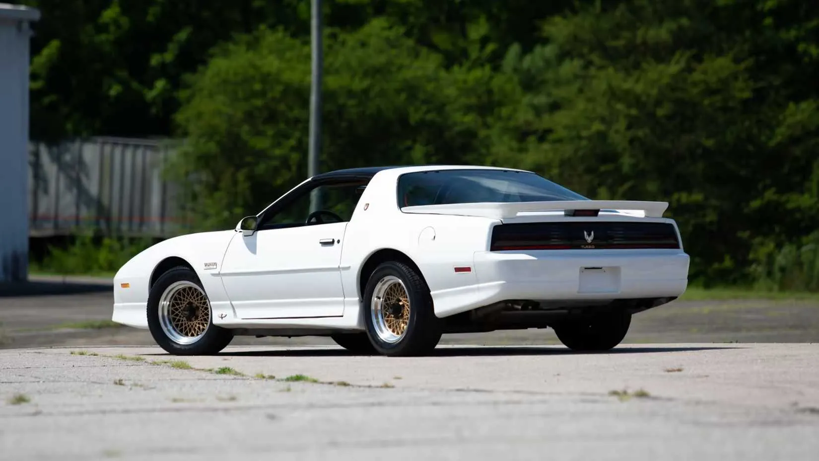 rear quarter shot of a white 1989 Pontiac Turbo Trans Am 20th Anniversary parked
