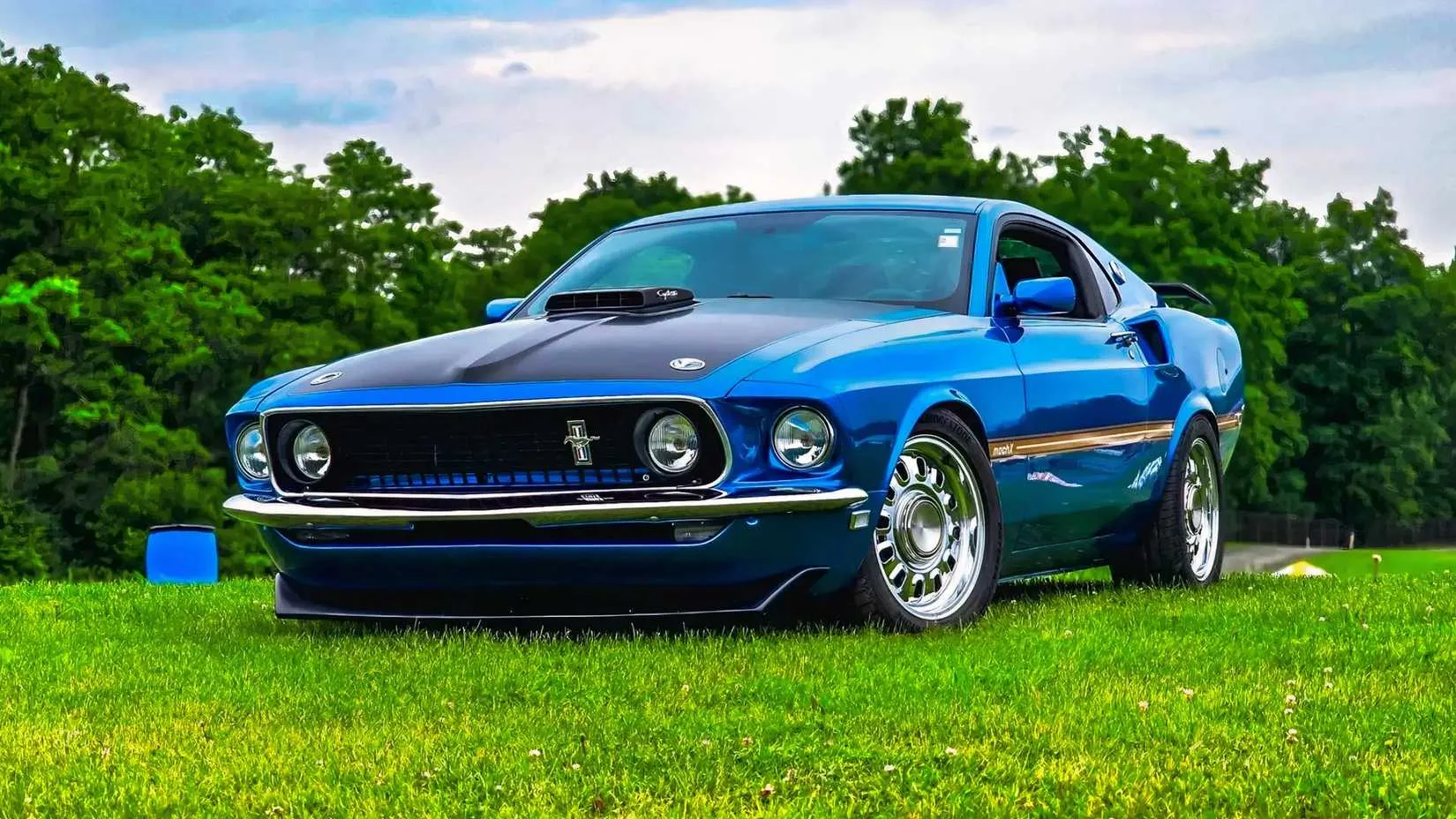 A side view of the 2012 Ford Mach X Mustang custom creation by Zero Given Garage, showcasing its 1969-inspired bodywork on an S197 chassis