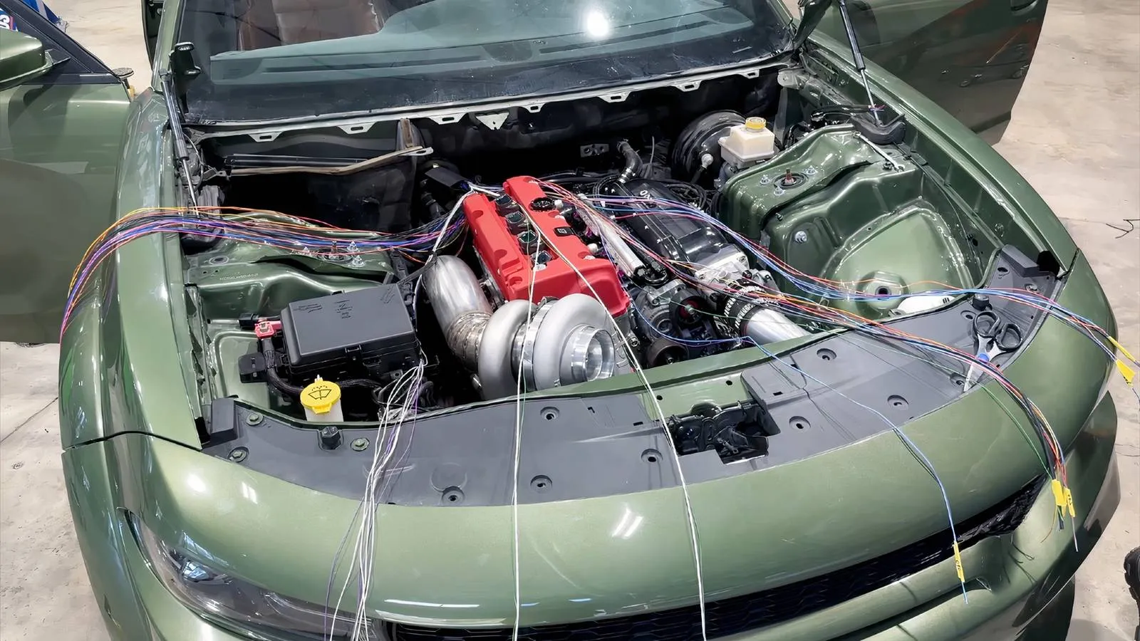 Honda K-series engine nestled in a Hellcat engine bay with a massive turbocharger