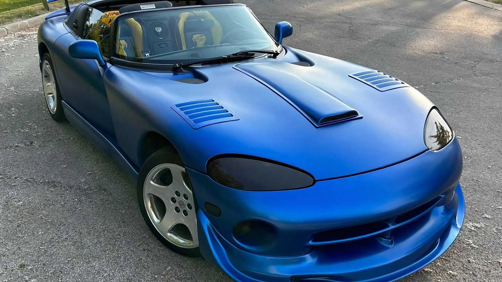 A 1999 Dodge Viper RT/10 with its long hood and aggressive stance parked on a show field