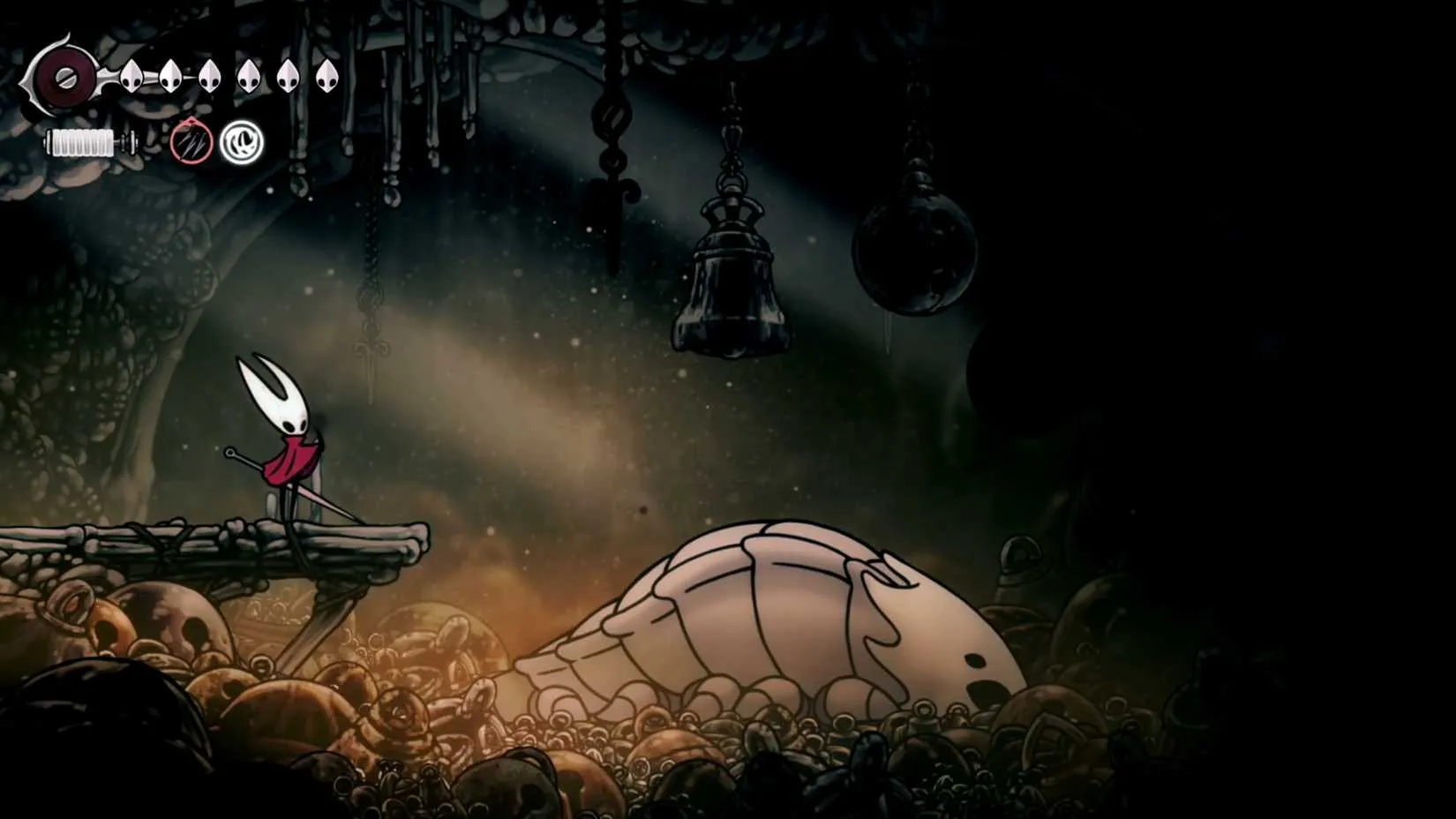 A towering Bell Beast stands in a dusty arena, its bell-shaped body gleaming as it prepares to be ridden by Hornet.