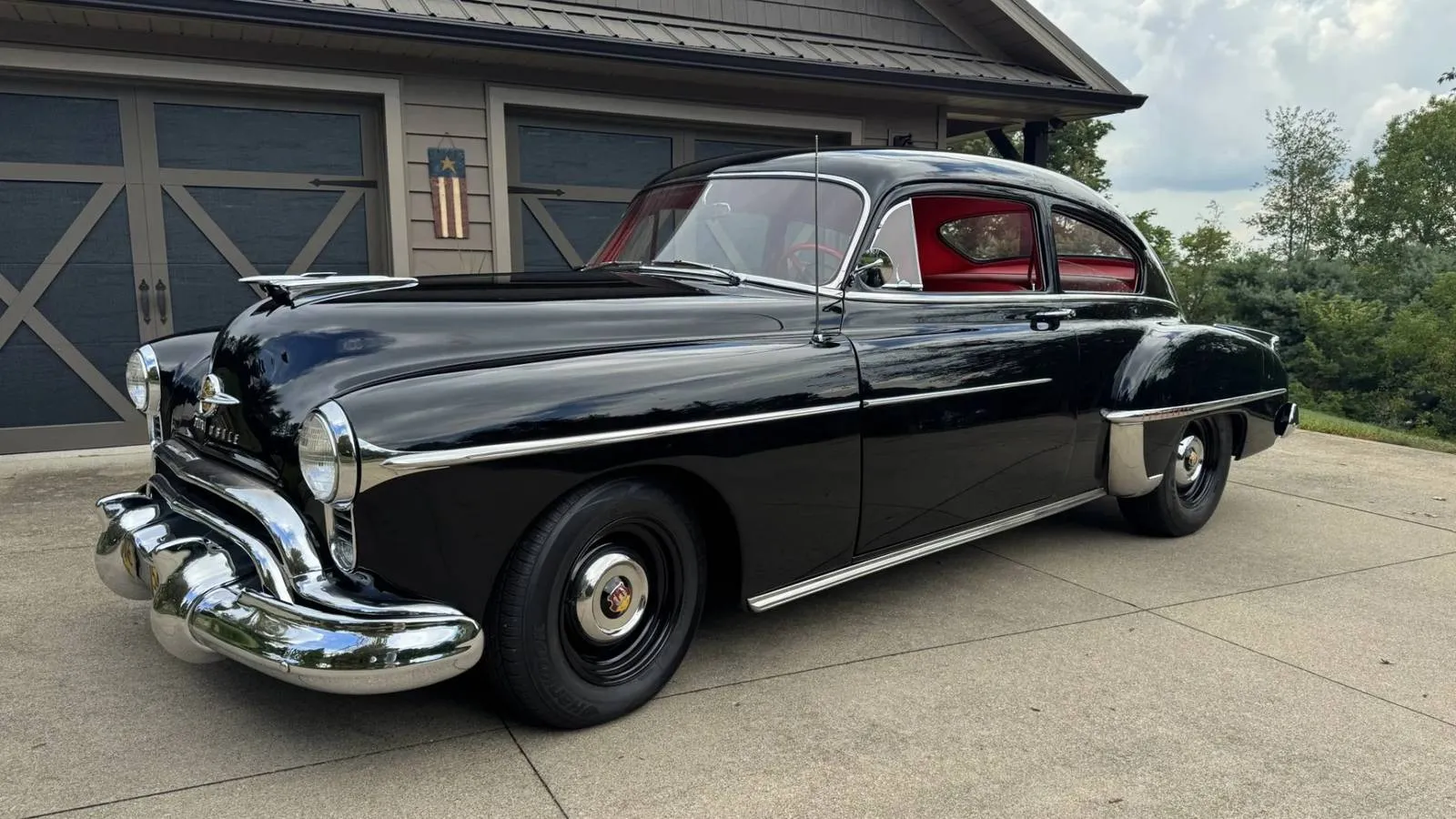 Black 1950 Oldsmobile Futuramic 88 Club Sedan with dark wheels and chrome accents