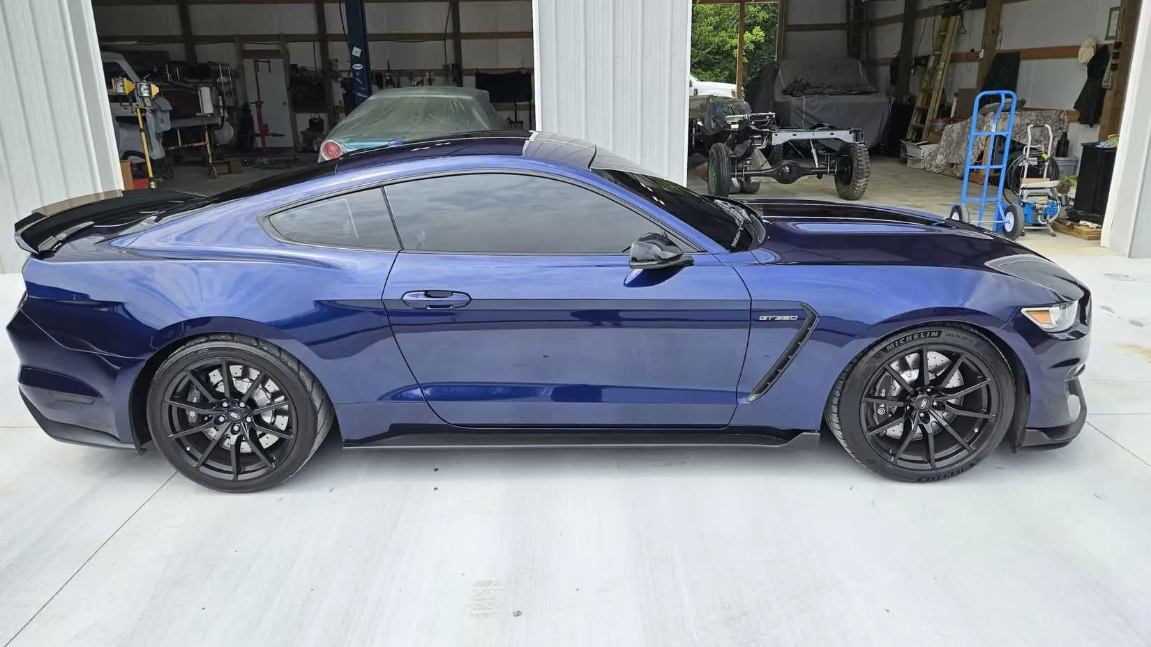 Blue Shelby GT350 side on the road